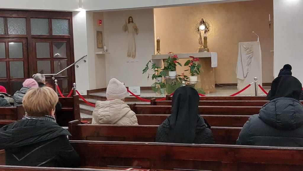 A parish community at the adoration of the Blessed Sacrament exposed in the monstrance